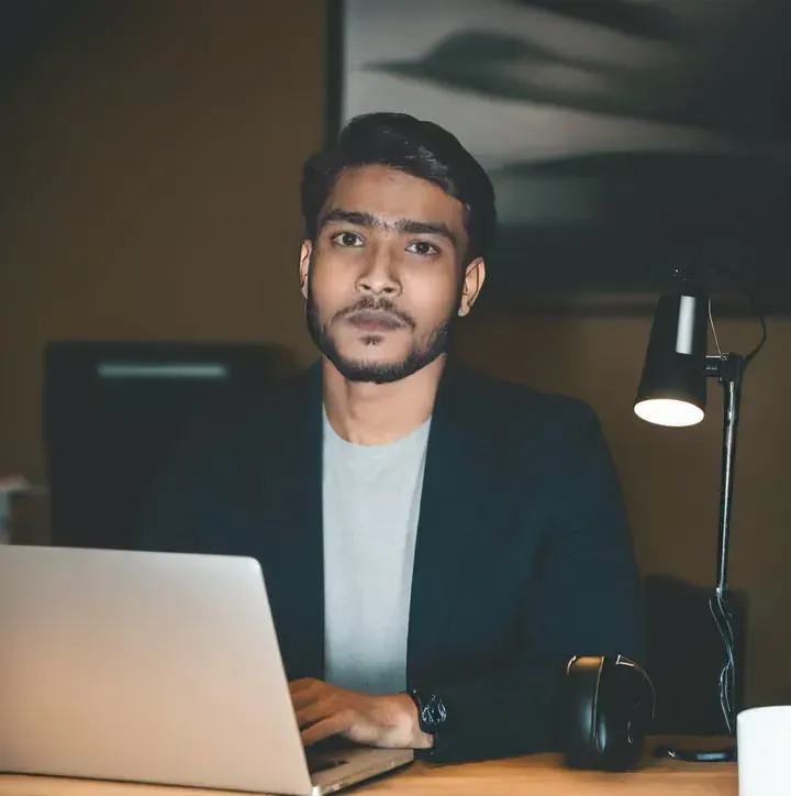 Selimuzzaman Afridi, web designer and SEO specialist, working on a laptop at his desk