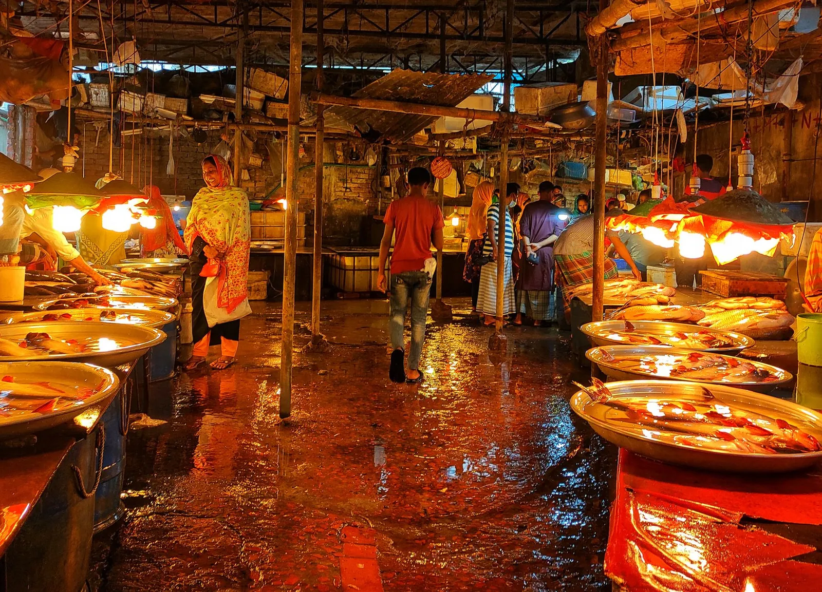 Fish market stalls under hanging lights in Bangladesh — the kind of trade a simple reorder app can serve