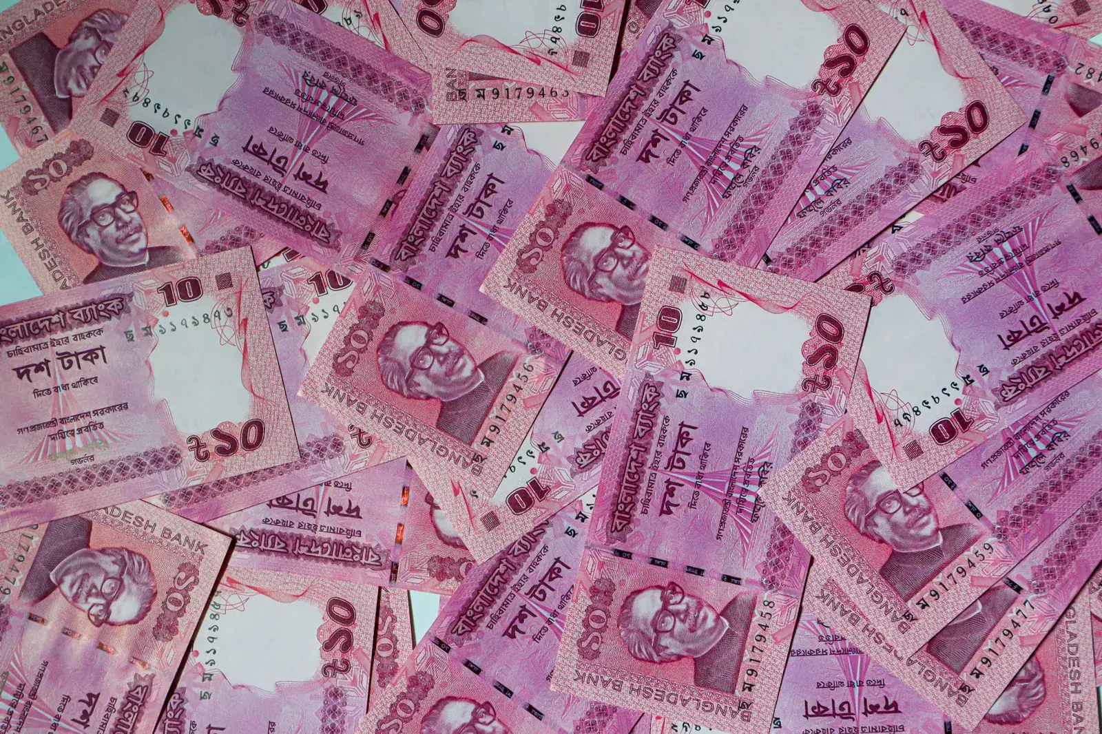 Bangladeshi taka banknotes laid out flat — web design and SEO packages priced and published in BDT