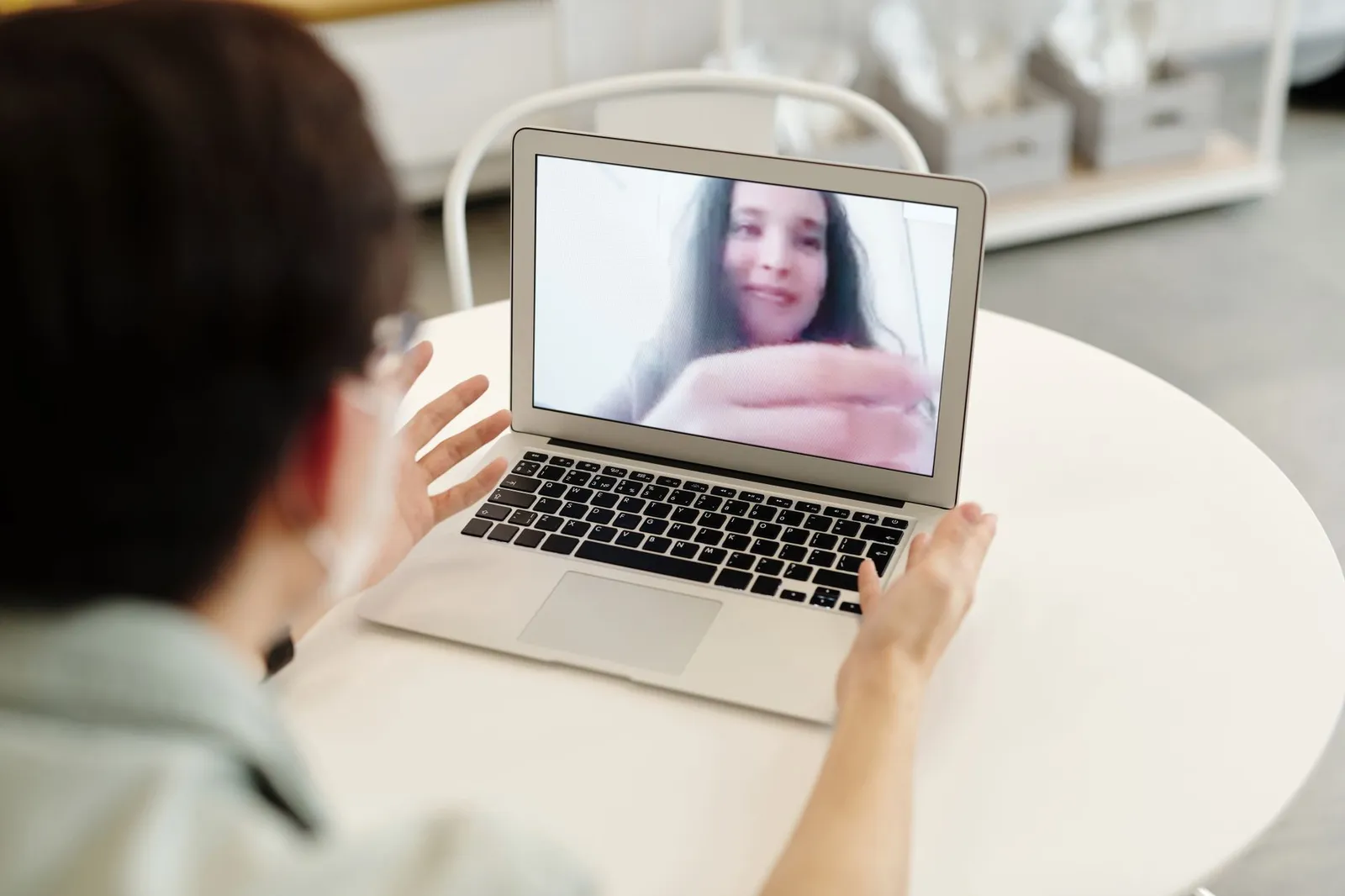 Business owner on a video call with a designer, talking through a website project remotely